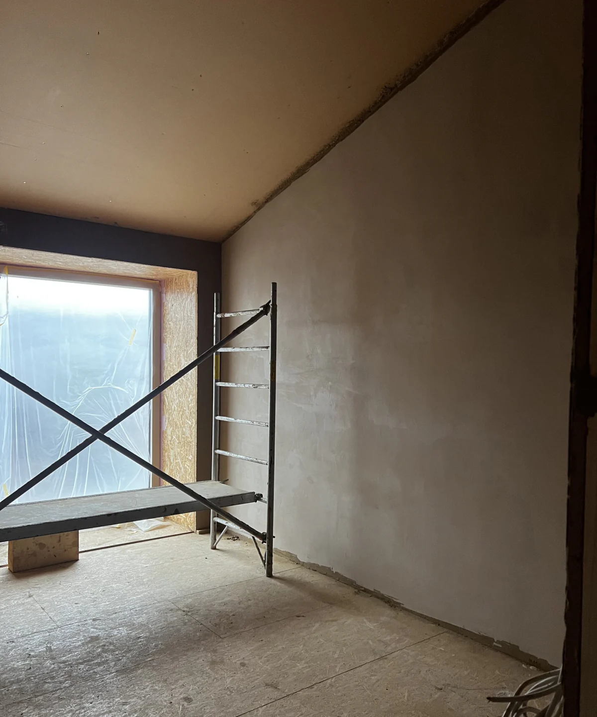 Room with the window and plastered walls